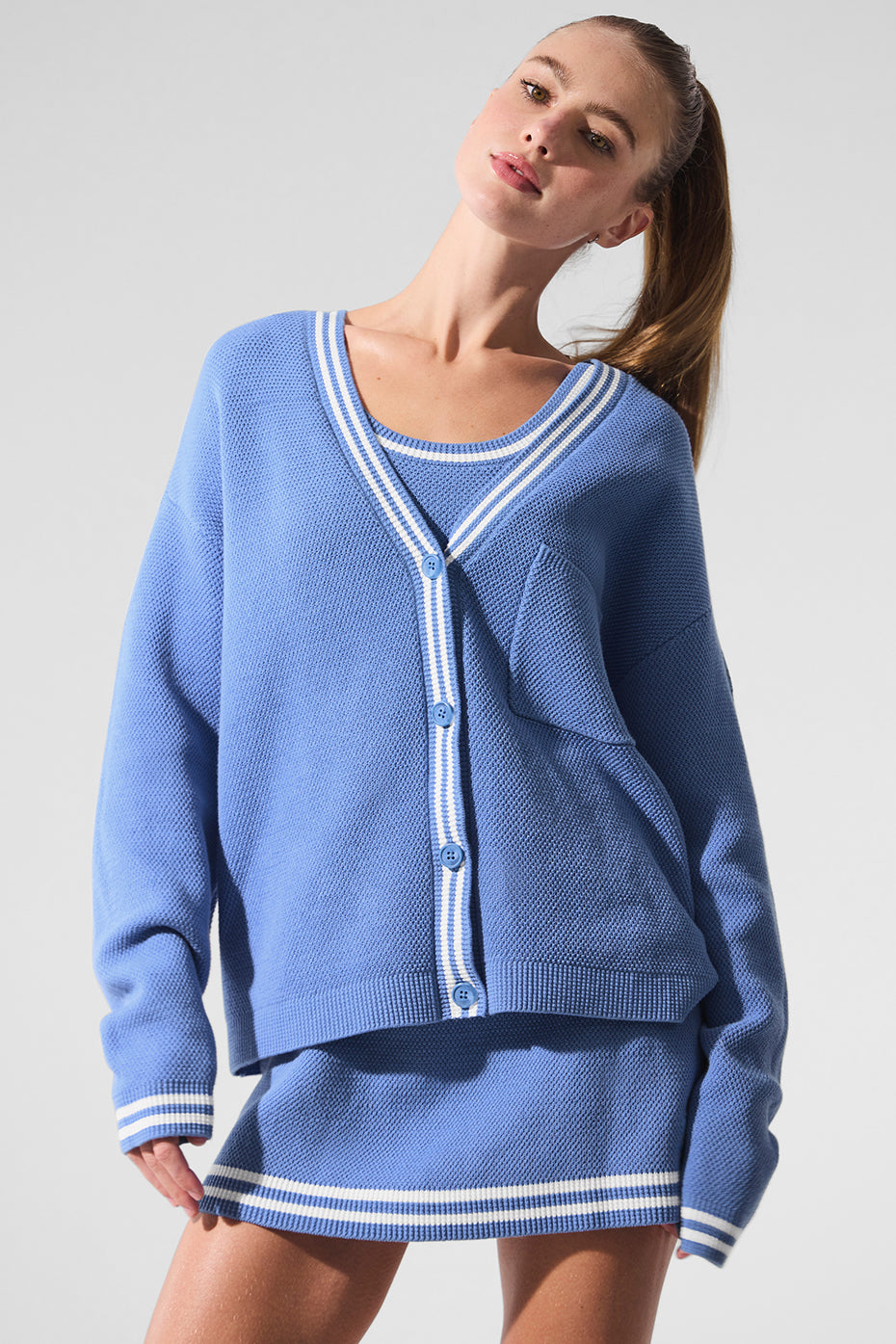 Detail shot showing ribbed cuffs and striped trim of womens sweaters from tennis collection