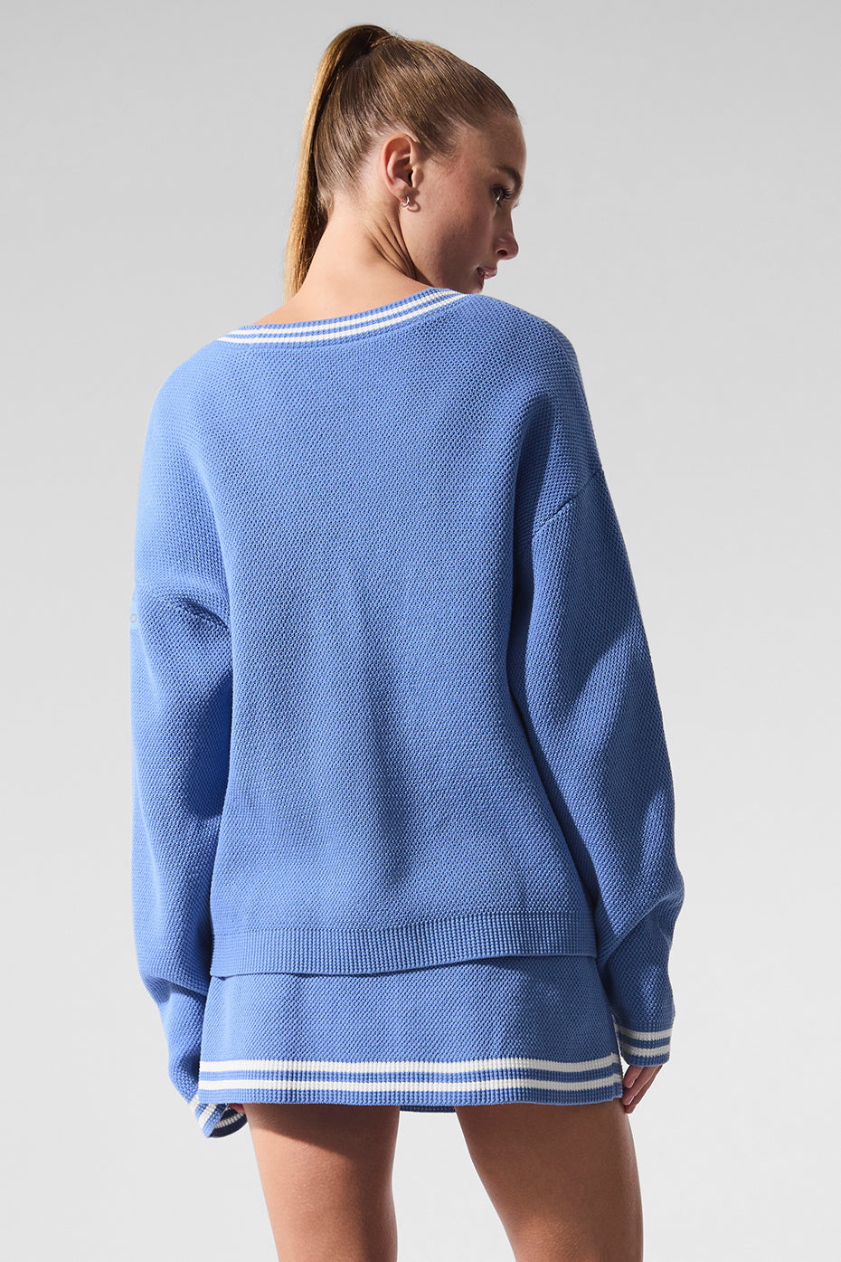 Back angle of black cardigan variant draped over shoulder, perfect for transitional weather
