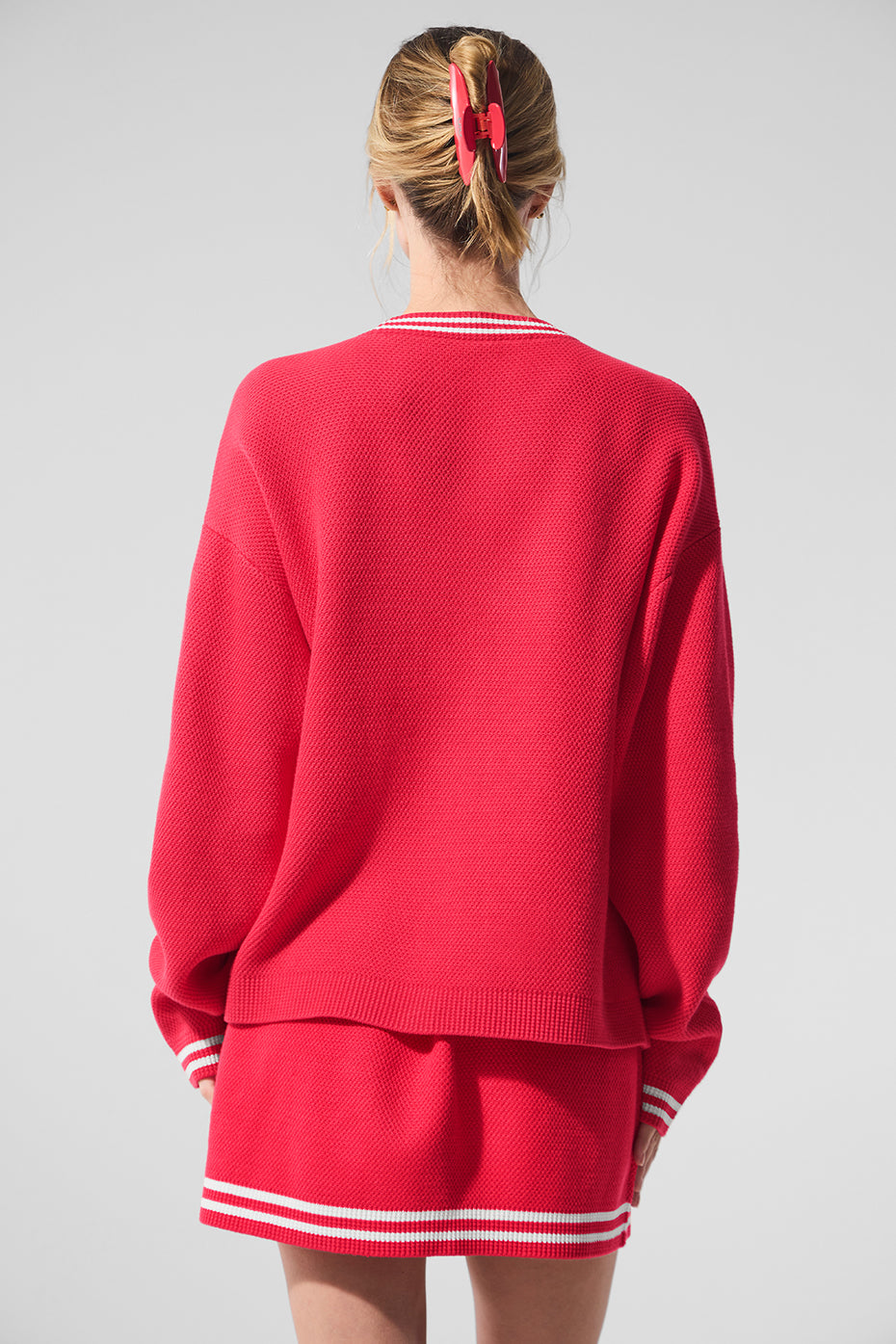 Close-up of the ribbed cuffs and four-button front of the cardigan.