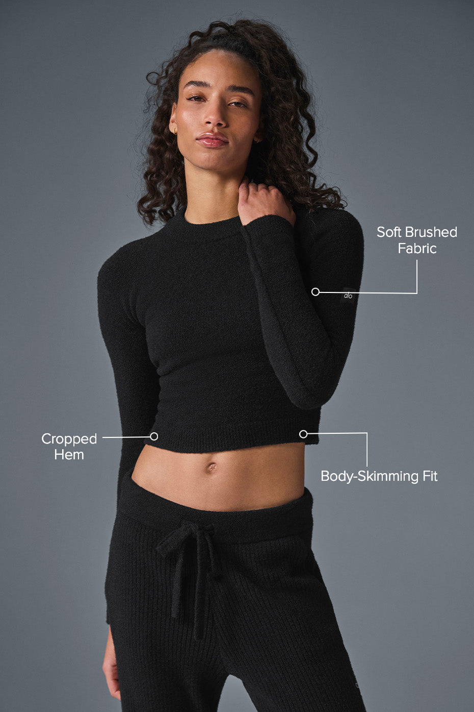 Model wearing cropped sweater with matching pants for a stylish look.