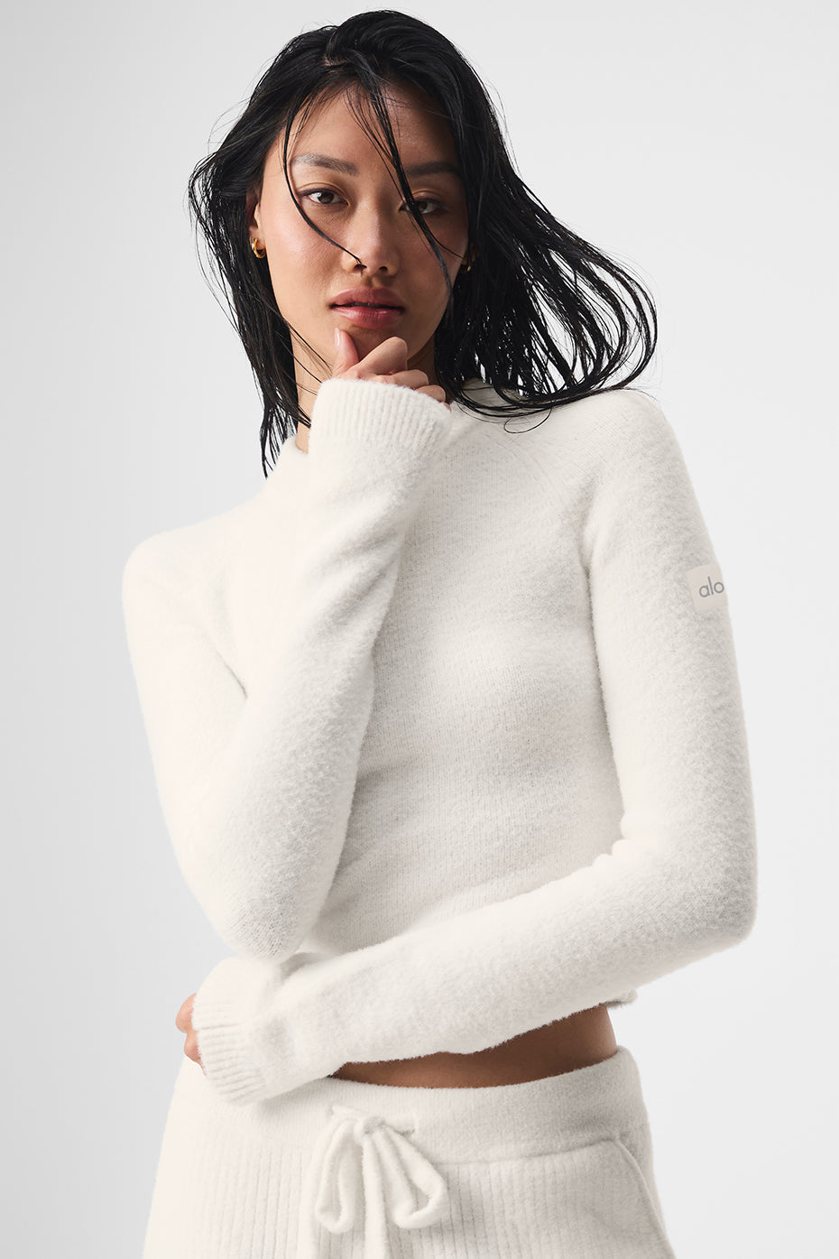Cozy ivory cropped cardigan sweater worn casually at home.