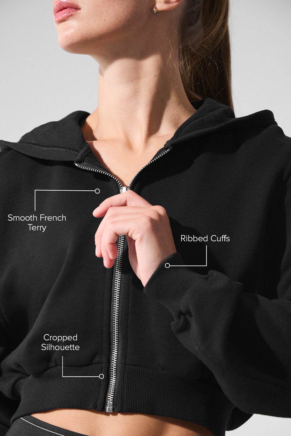 Model wearing a womens zip up hoodie outdoors, styled casually