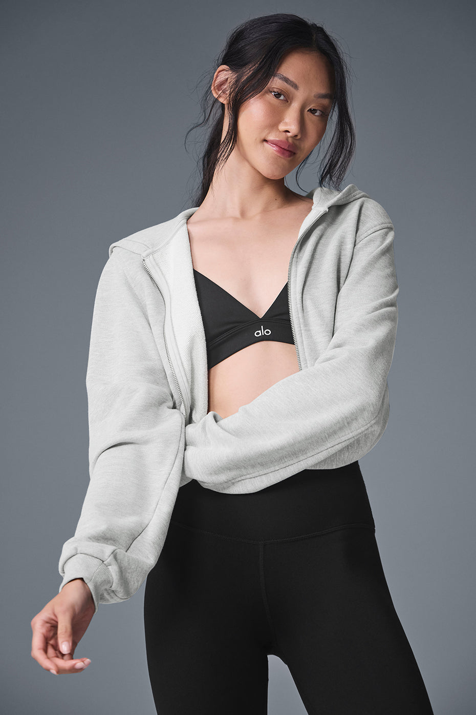 Close-up of the heather grey zip up hoodie with ribbed cuffs and sleek design