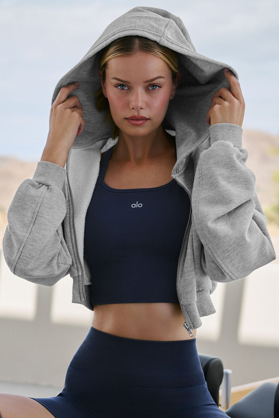 Close-up of the heather grey zip up hoodie with ribbed cuffs and sleek design