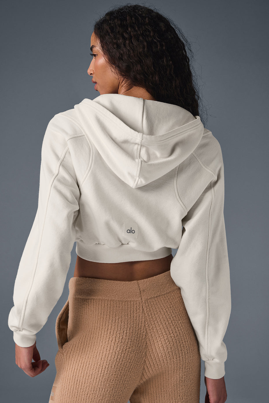 Styled outfit featuring the ivory zip up hoodie paired with high-waisted leggings