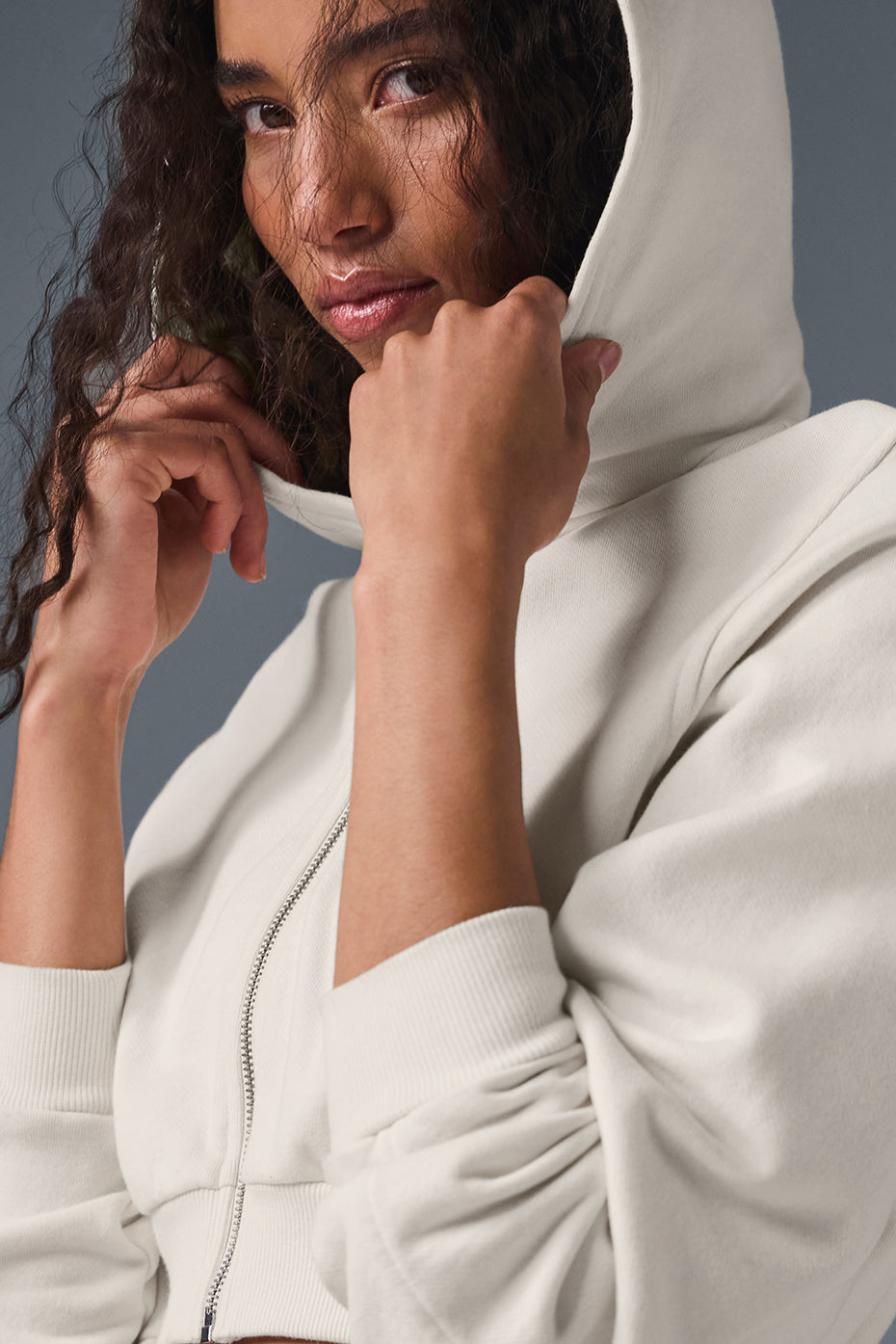 Front view of ivory zip up hoodie with cropped silhouette and hood