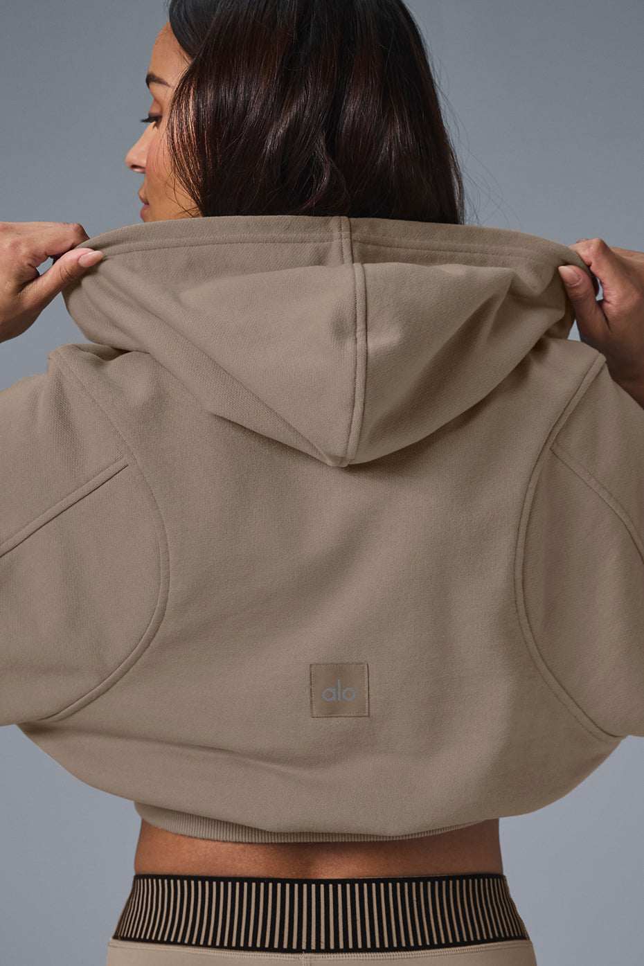 Close-up of the ribbed cuffs and seamed details on the hoodie