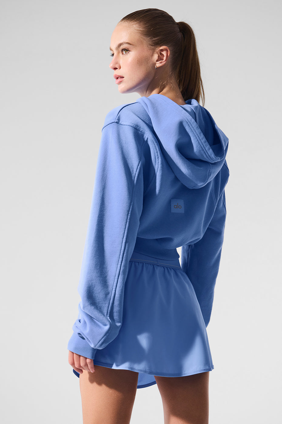 Back view showing the streamlined, pocketless design of the hoodie