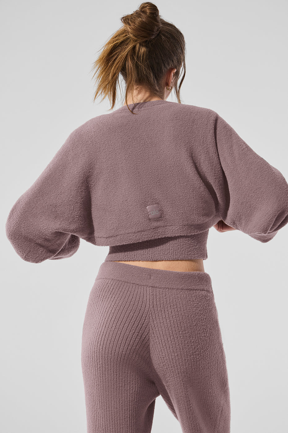 Model wearing the shawl sweater with trousers for a chic evening look.