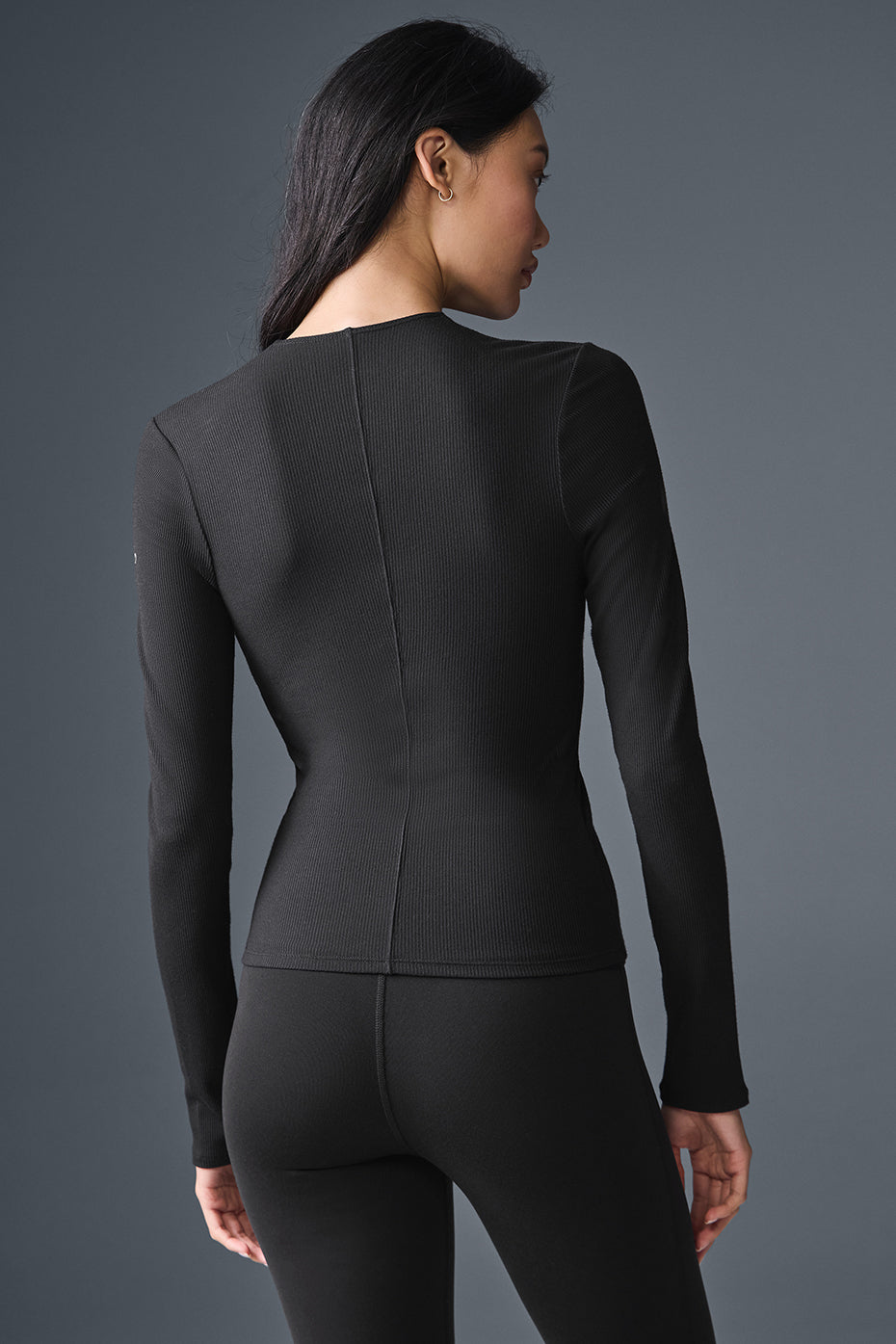 Detail shot of the ribbed texture and adjustable V-neck on this long sleeve shirt.