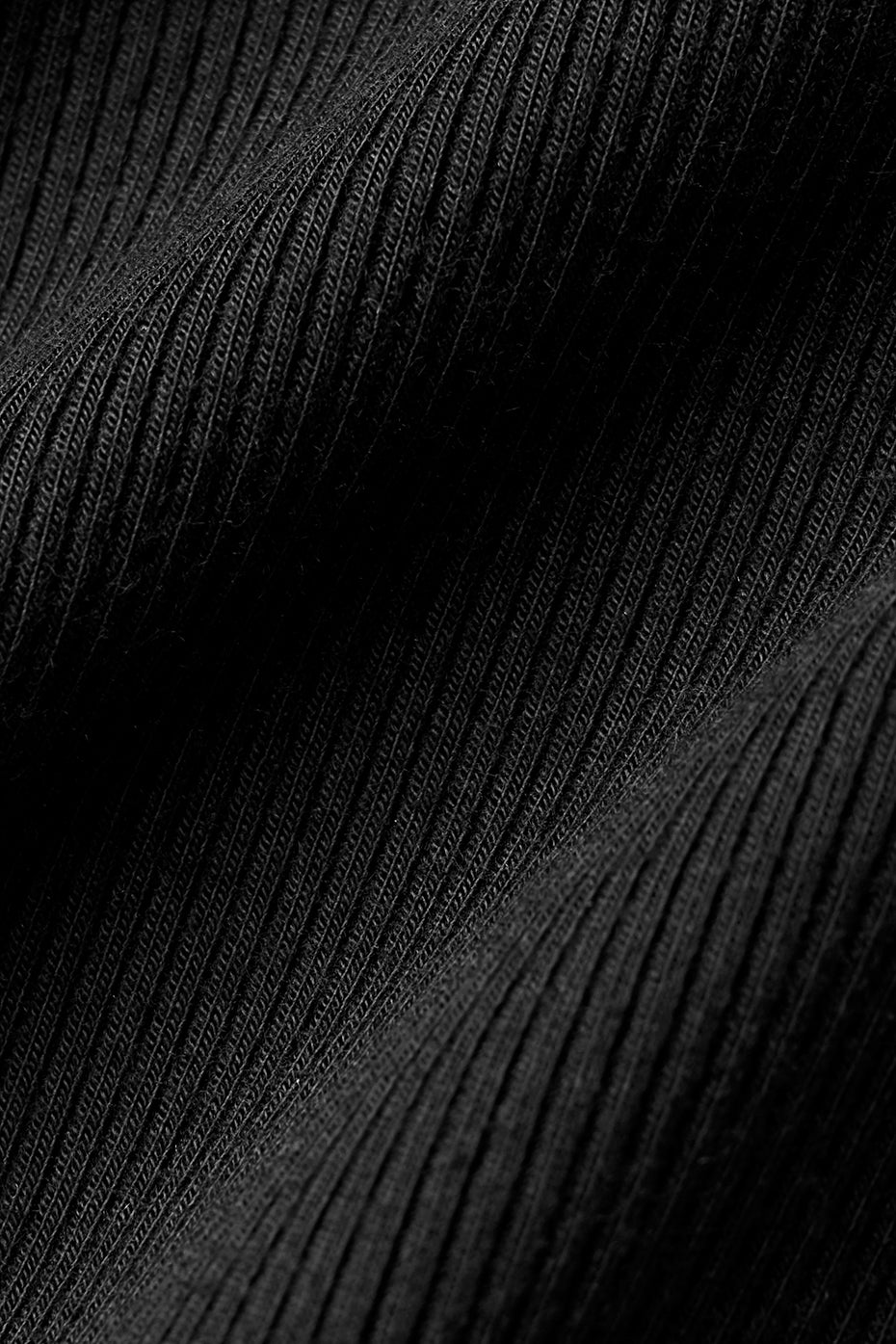 Detail shot of the ribbed texture and adjustable V-neck on this long sleeve shirt.