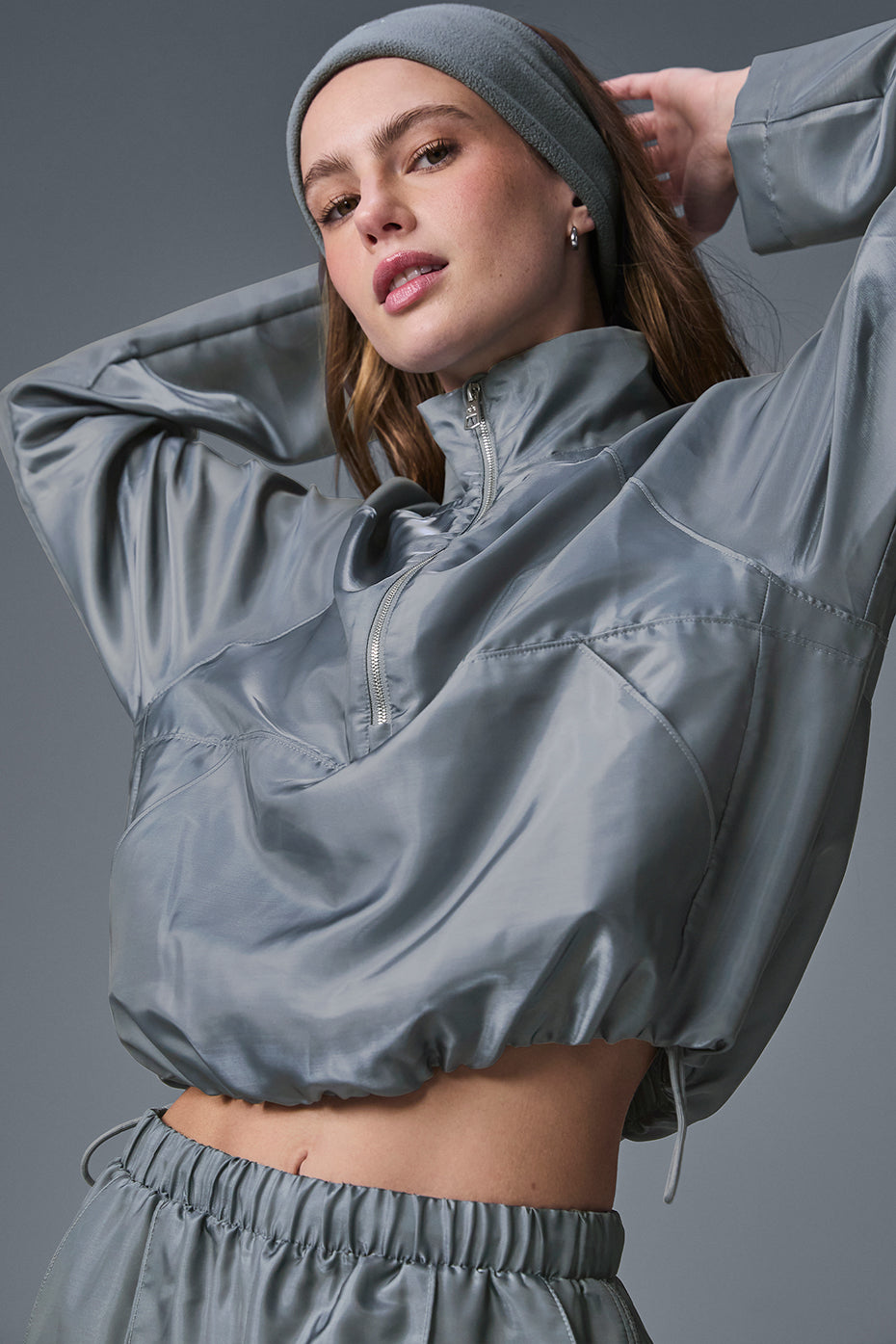 Back view of the Cropped Afterglow Pullover, showcasing its reflective fabric ideal for workouts.