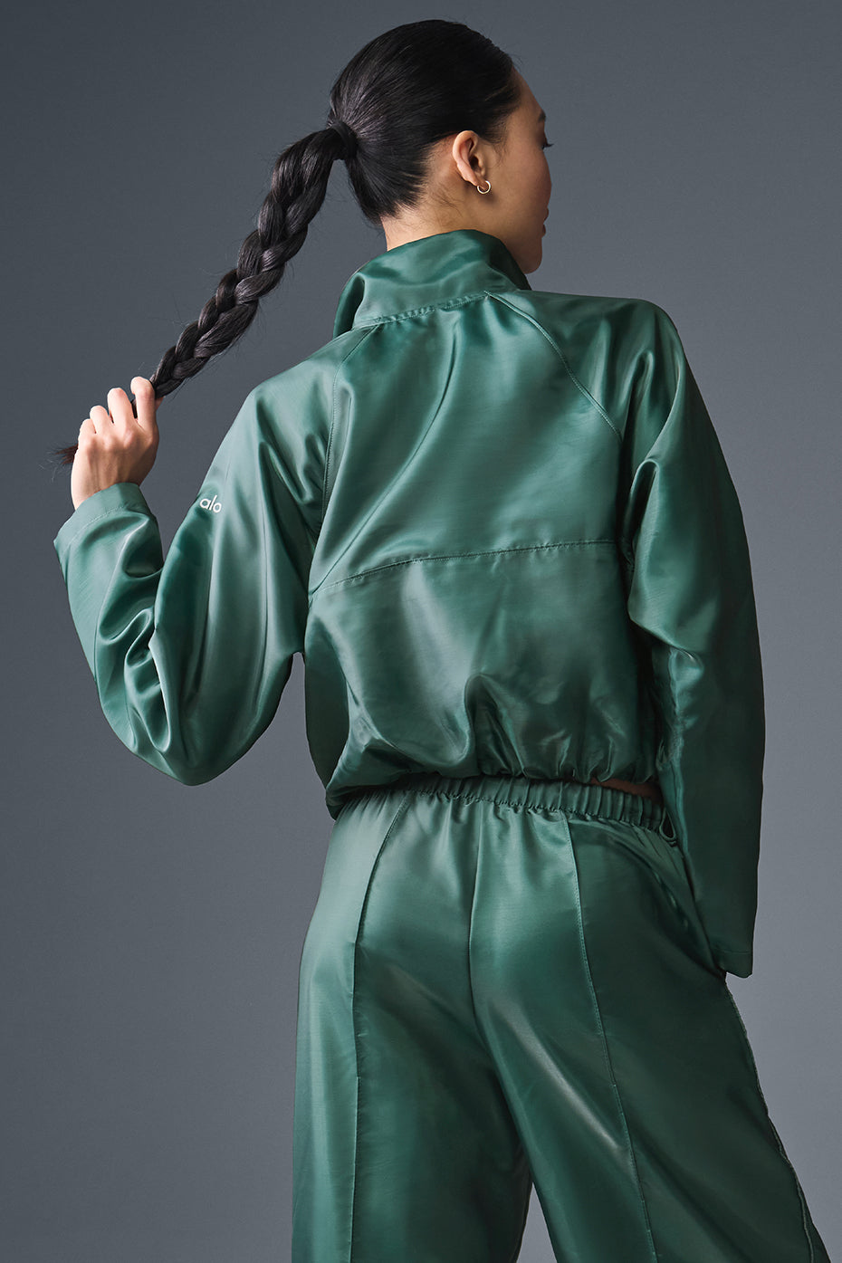 Close-up of the reflective fabric on the Afterglow Cropped Pullover in Winter Ivy