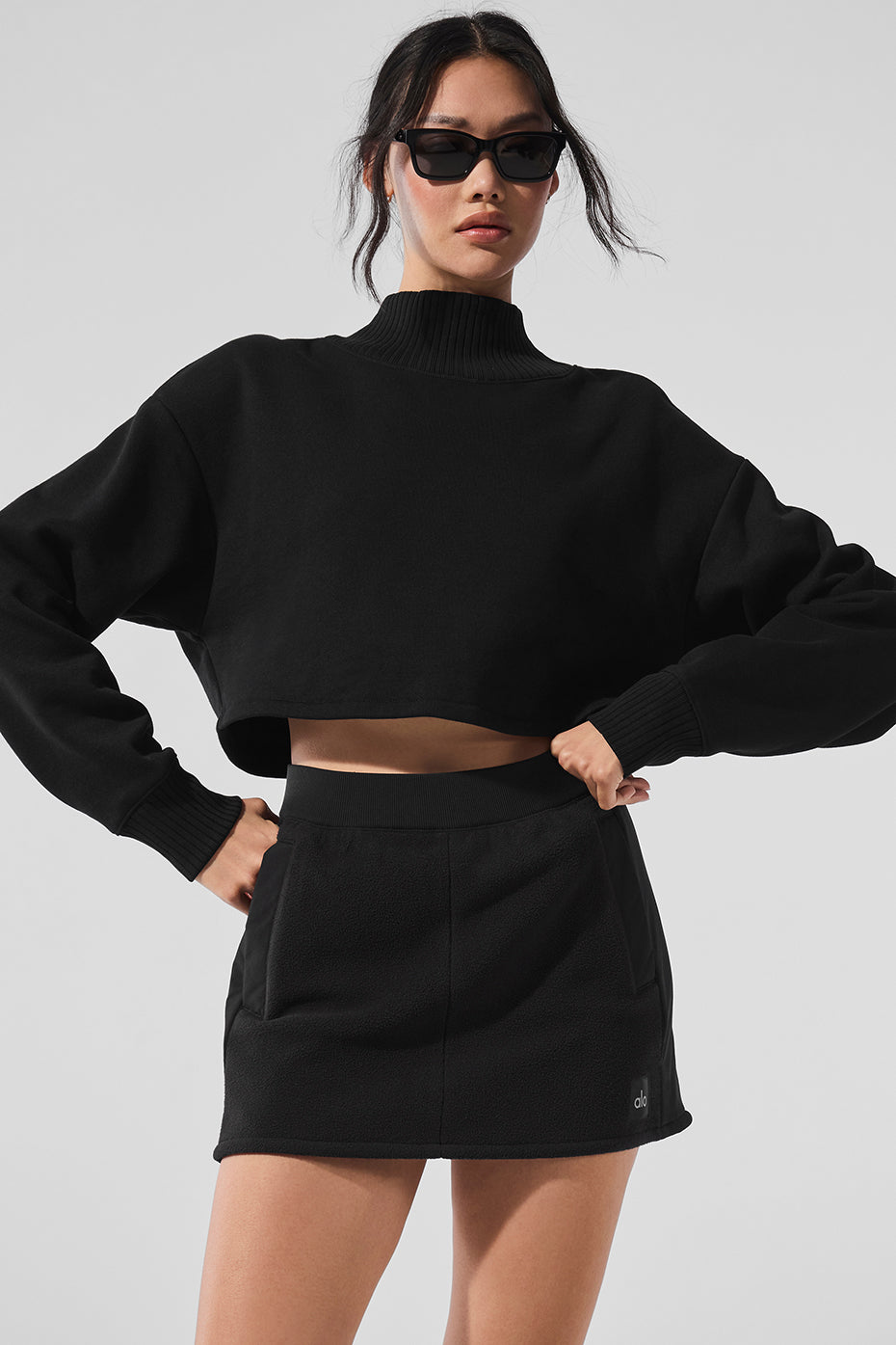 Close-up of the ribbed mock neck on the black cropped coverup.