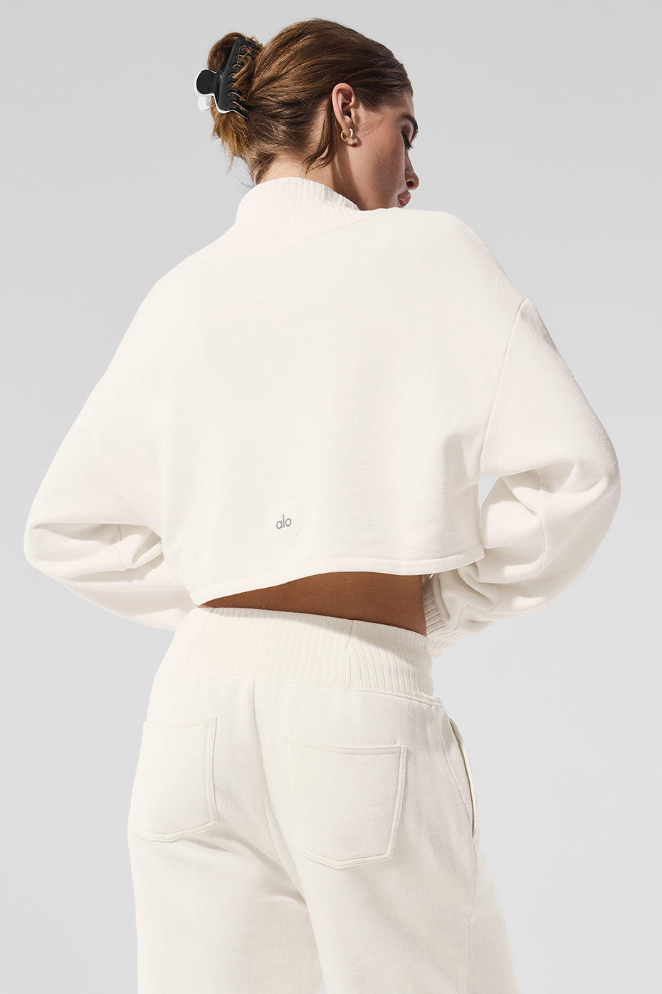 Closeup of ribbed mock neck and cropped hem showing texture