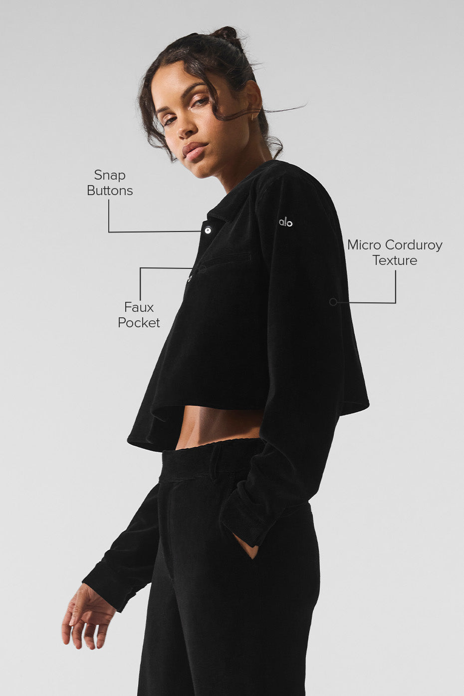 Model wearing cropped button down shirt with wide leg trousers.