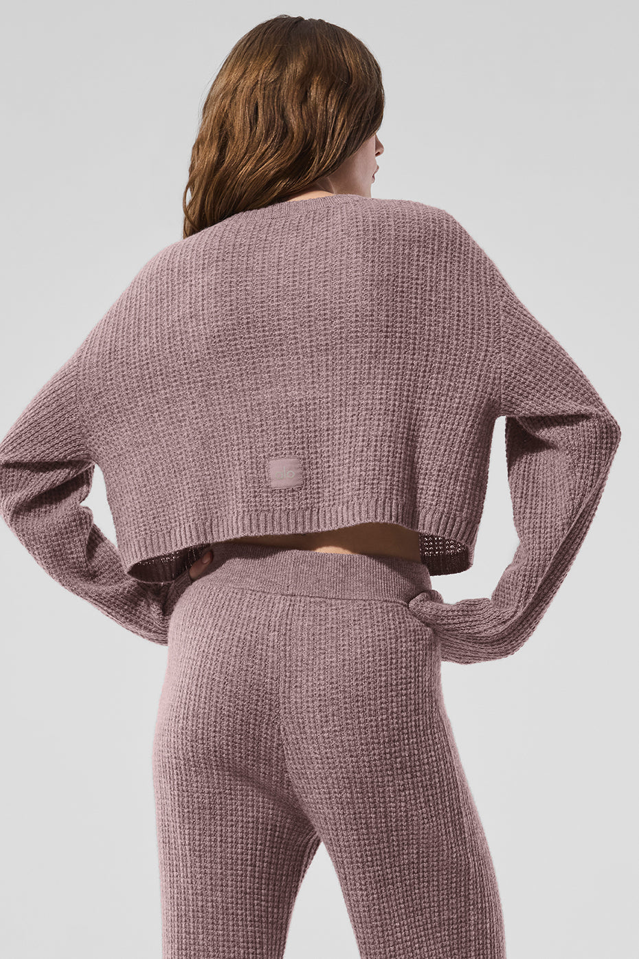 Close-up of the button-front closure on the cashmere cardigan.