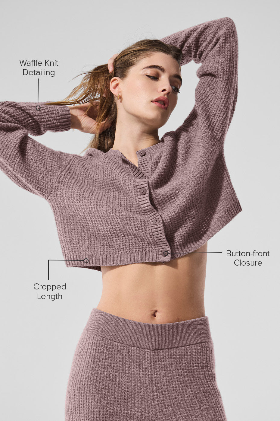 Side view showcasing the cropped silhouette of the black cashmere cardigan.