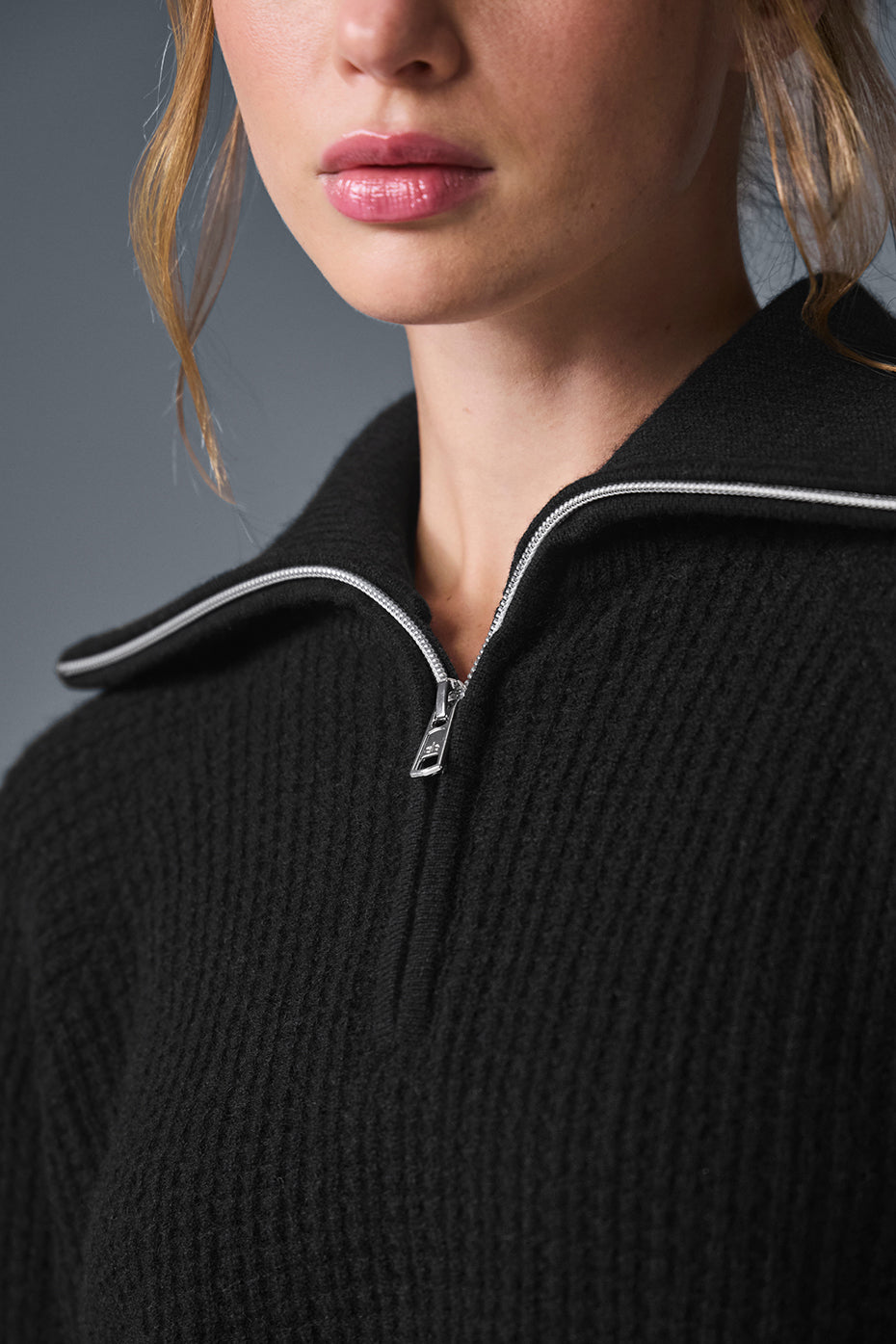Close-up of the black cashmere pullover showcasing its plush waffle texture.