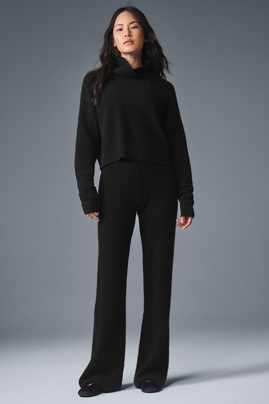 Front view of the luxurious black cashmere pullover showing its waffle texture.