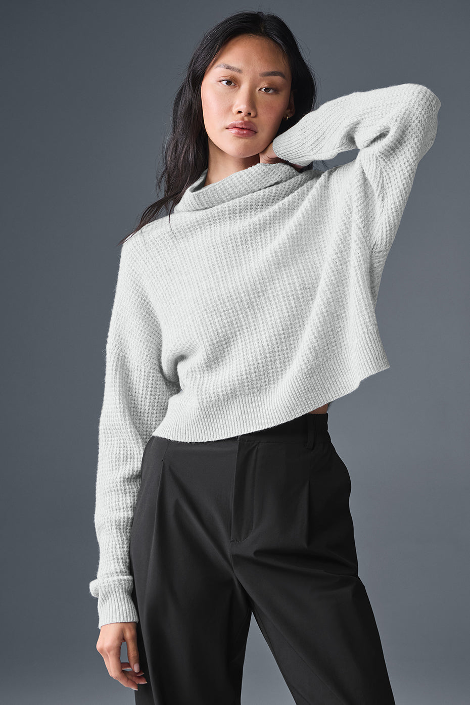 Men's cashmere pullover sweater displayed in a cozy living room setting.