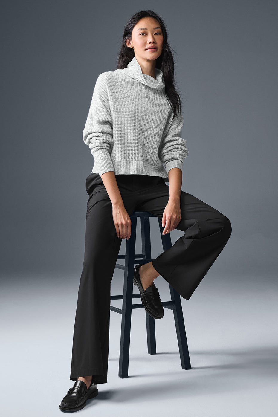 Close-up of the waffle turtleneck on a plush sweater in natural light.