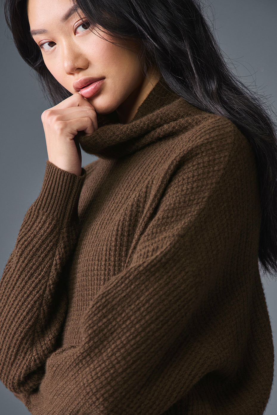 Closeup of waffle knit texture and turtleneck neckline for seasonal wear