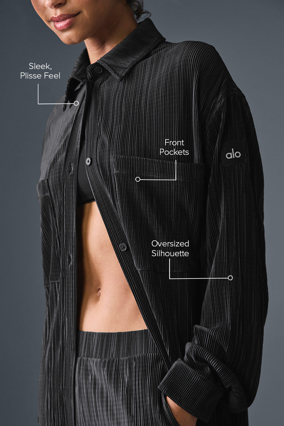 Close-up of the buttons on the black plisse shirt dress.