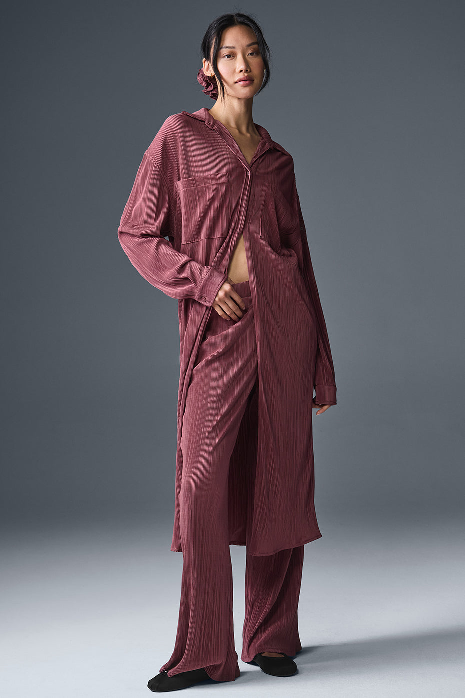 Front view of the chic burgundy plisse shirt dress on a model.