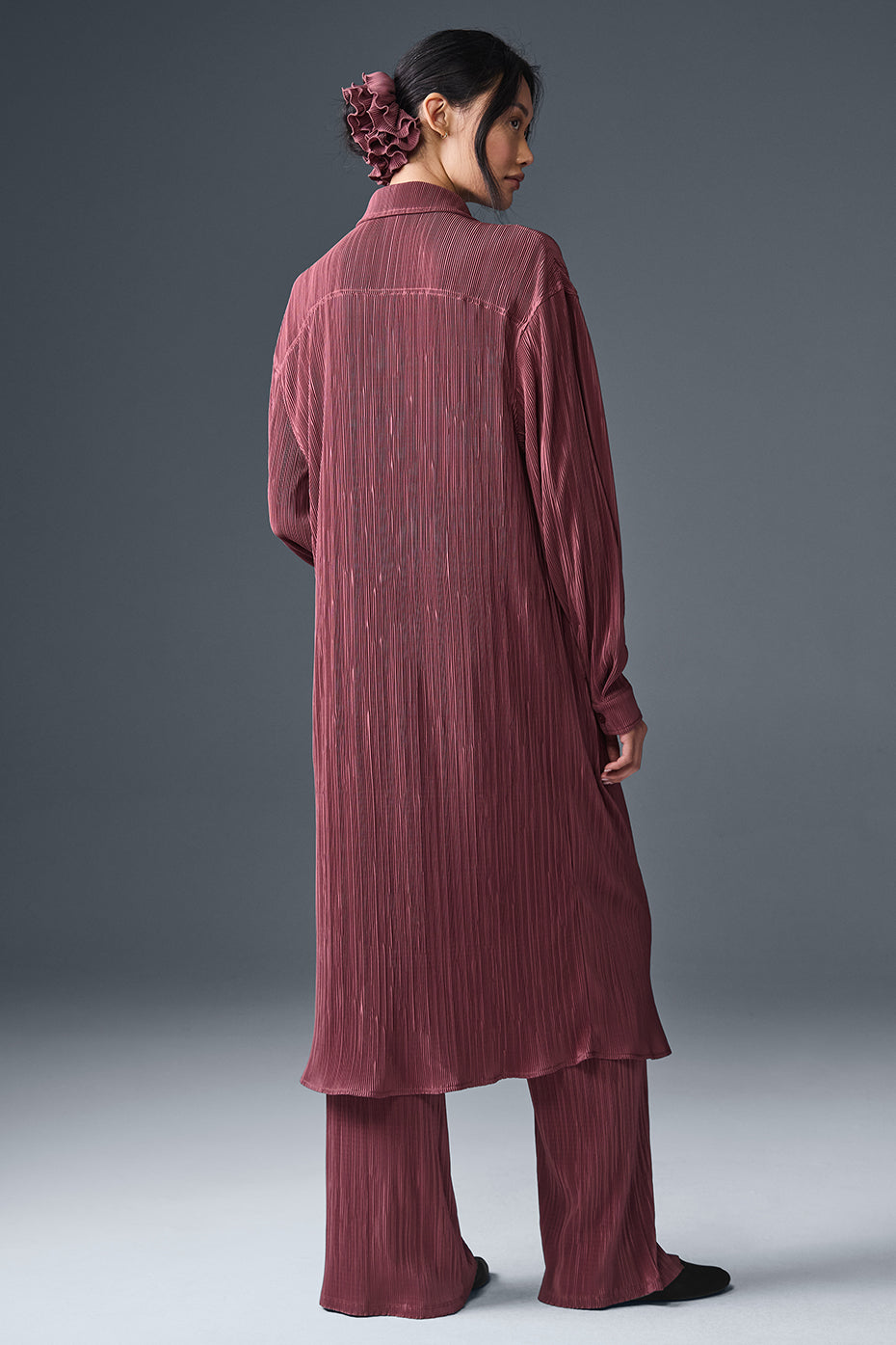 Front view of the chic burgundy plisse shirt dress on a model.
