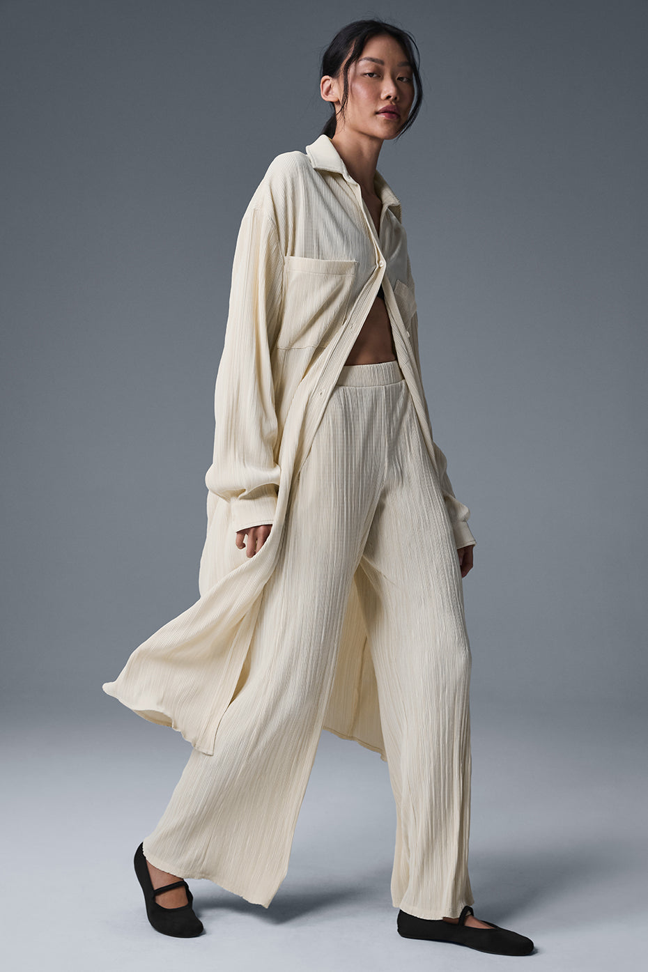 Front view of the Micro Plisse Shirt Dress in oat milk, showcasing its elegant design.