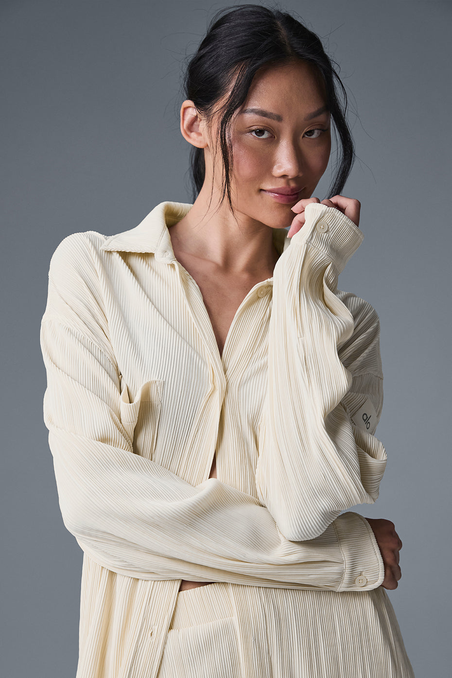 Front view of the Micro Plisse Shirt Dress in oat milk, showcasing its elegant design.