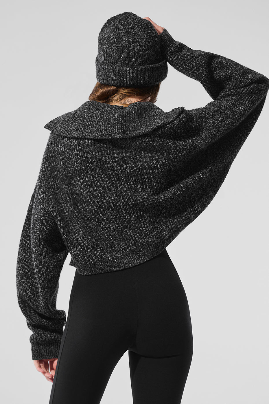 Front view of the black marl quarter zip pullover sweater, showcasing its boxy fit.