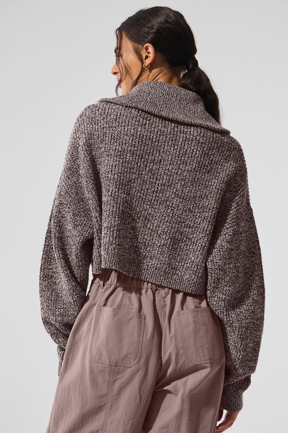Close-up of the exaggerated collar on the cropped turtleneck sweater.