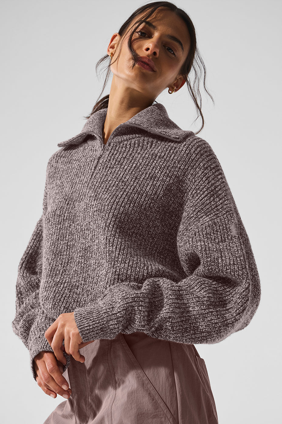 Model wearing the quarter zip pullover sweatshirt with casual bottoms.