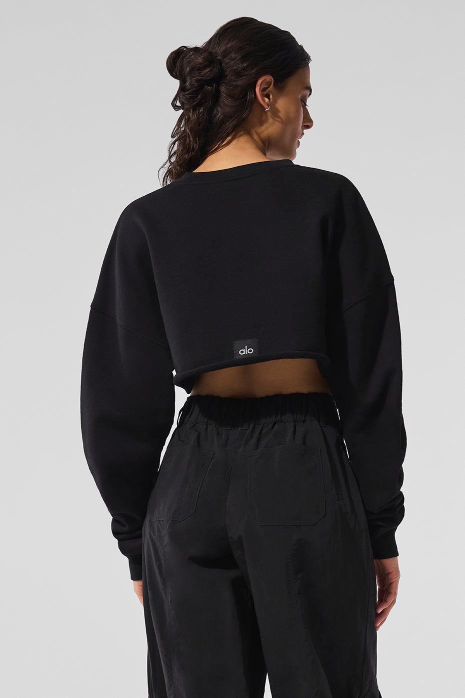 Close-up of the black cropped pullover showcasing its fabric texture.
