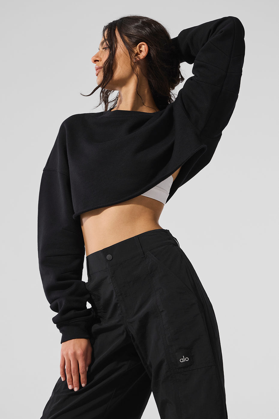 Model wearing the Extreme Cropped Pullover with a tennis skirt on a sunny day.