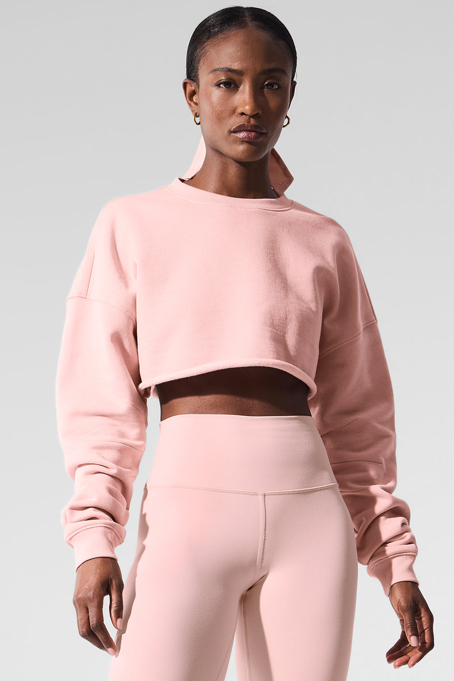 Model wearing the hot pink pullover sweater with a tennis skirt.