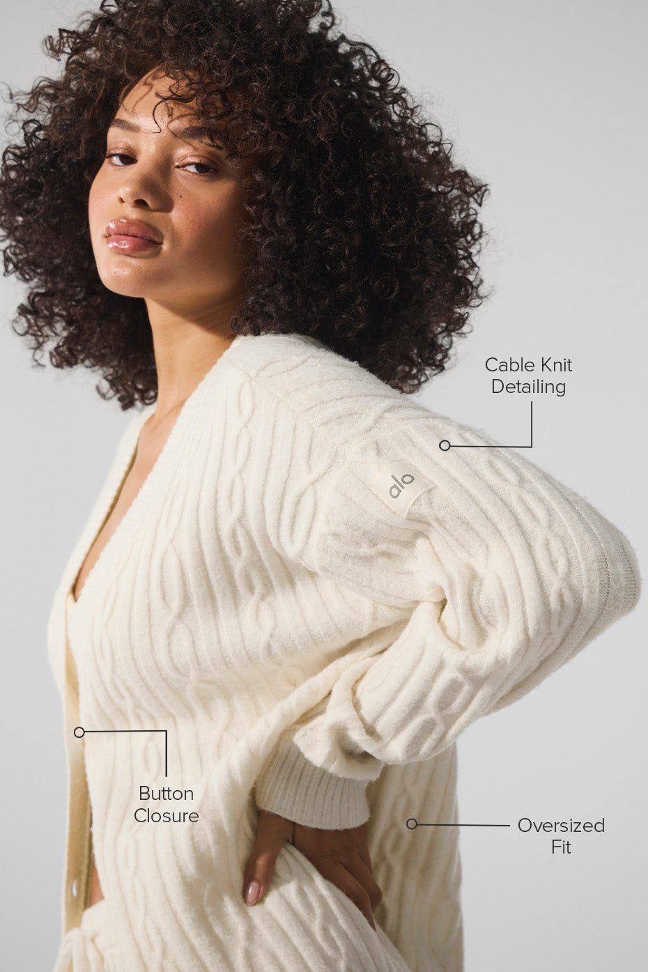 Close-up of the cable knit texture of the ivory cardigan.