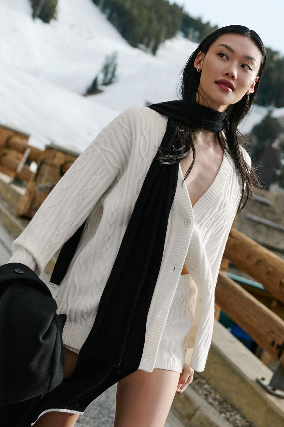 Front view of woman in oversized ivory cardigan outdoor.