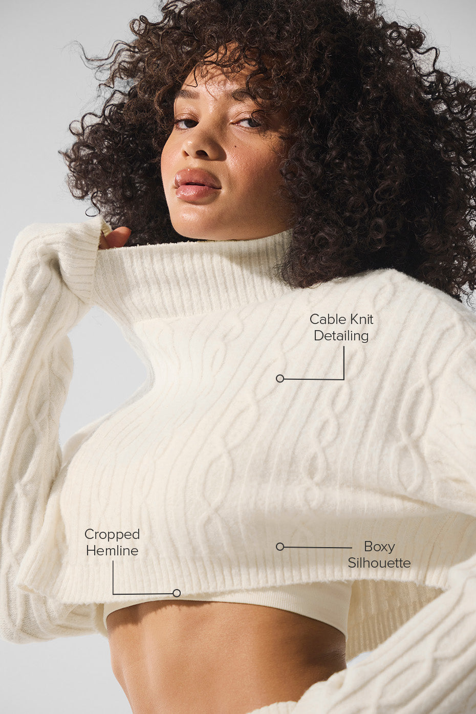 Side view of cozy black turtleneck sweater layered with winter shorts.