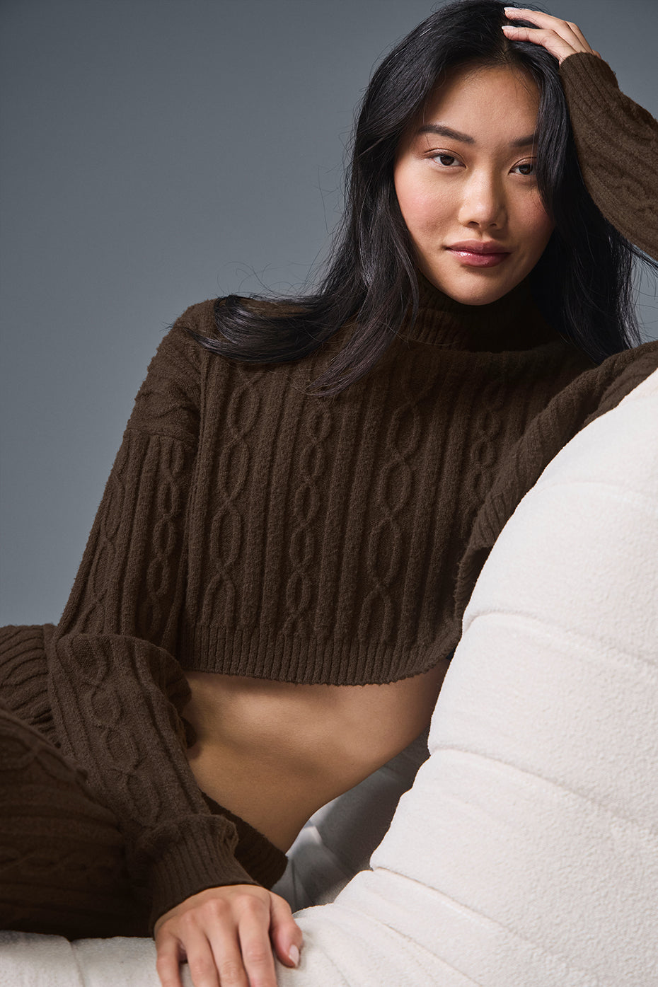 Close-up of espresso cable knit turtleneck sweater texture