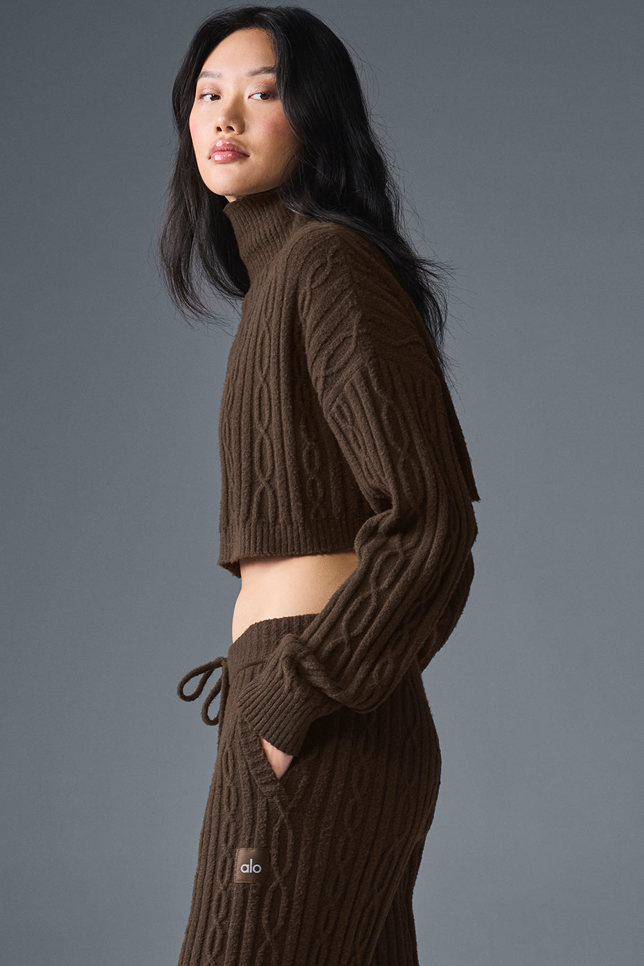 Cropped black turtleneck sweater paired with denim jeans