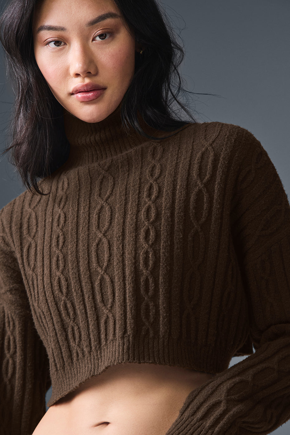 Close-up of espresso cable knit turtleneck sweater texture