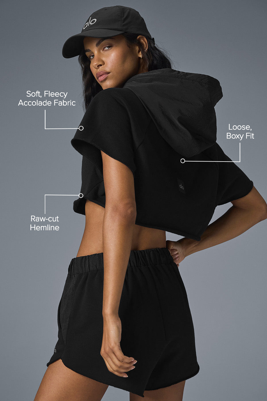 Side angle of cropped hoodie paired with high-waisted leggings.