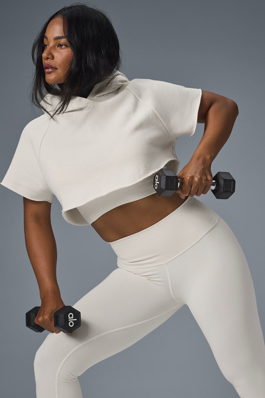 Front view of ivory cropped zip up hoodie with cutoff sleeves.