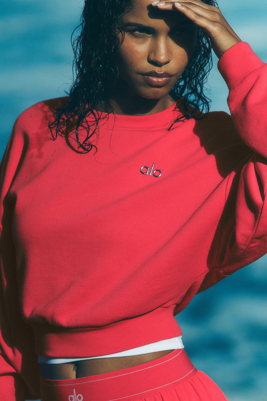Front view of the Cropped Accolade Crewneck Sweatshirt in candy red.