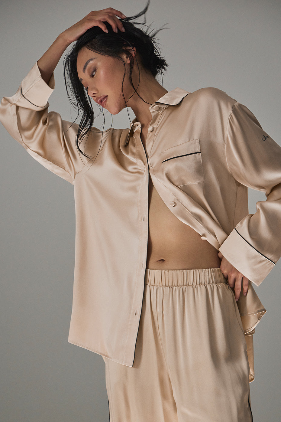 Close-up of contrast piping detail on the silk button down shirt.