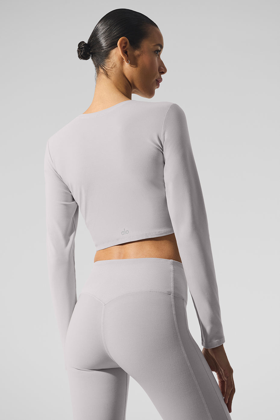 Close-up of the fabric texture of the long sleeve crop top, emphasizing its soft, washed look