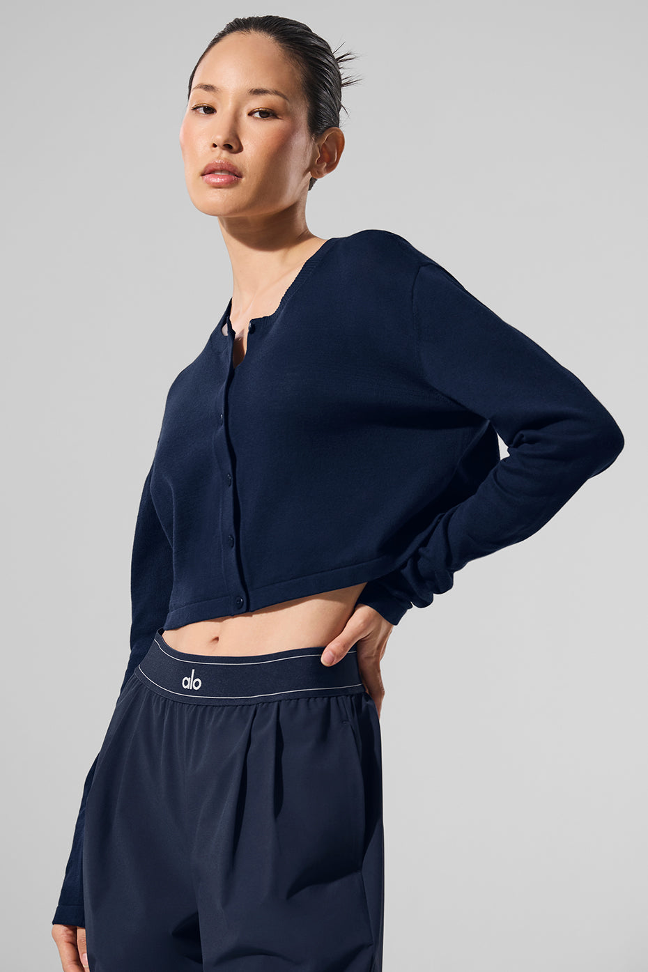 Close-up of the crew neckline on the navy cardigan.